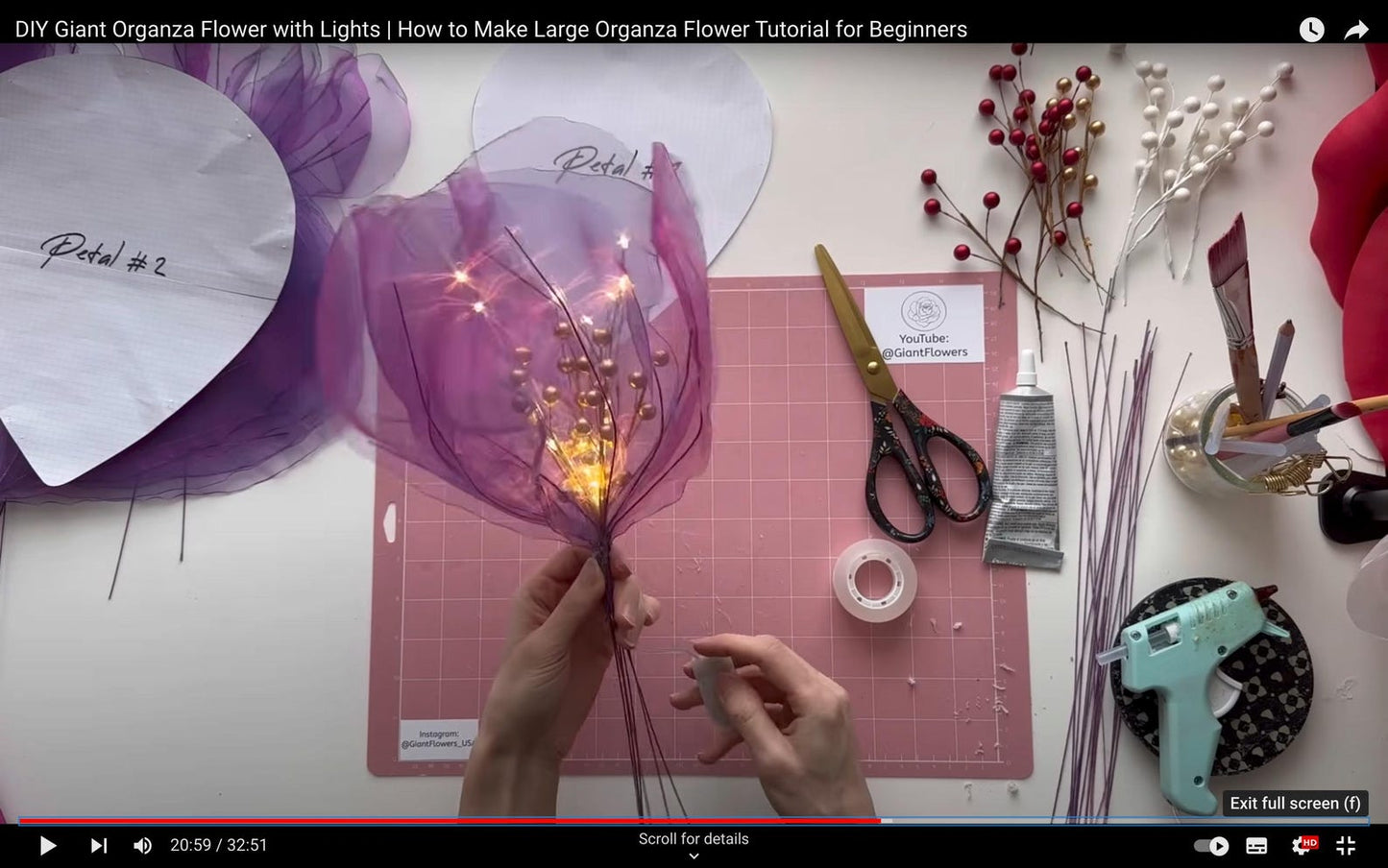DIY Giant Organza Flower with Lights tutorial on a table with materials and tools.