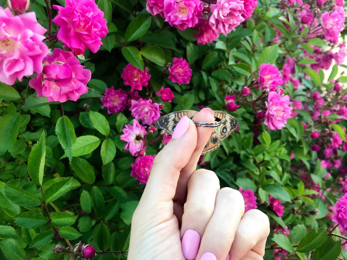 Close-up of butterfly ring on index finger