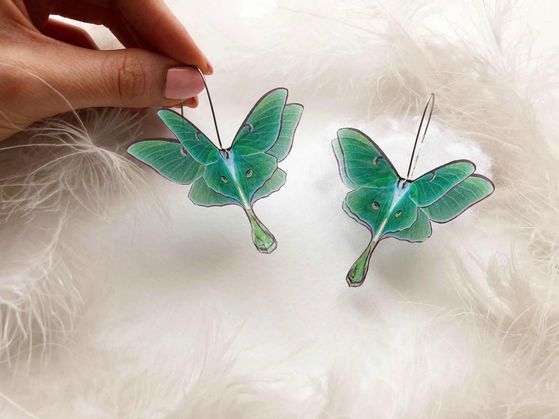 Girl wearing cool jacket and green luna moth earrings