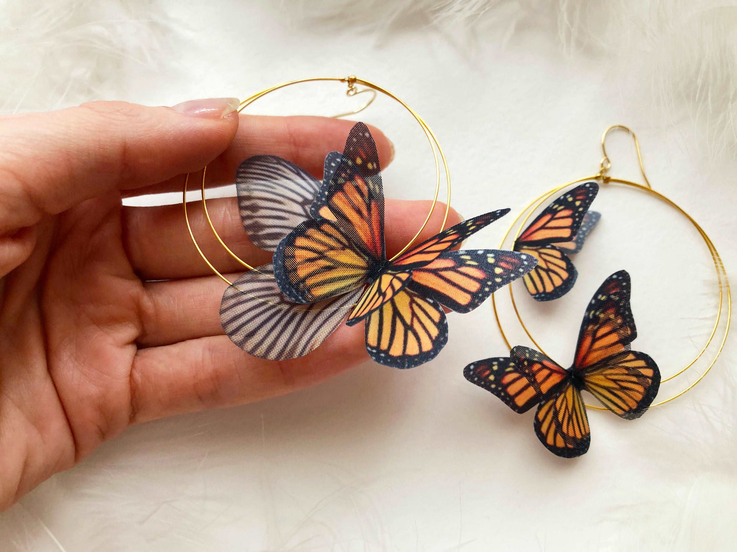 Monarch Butterfly Hoop Earrings on a model, showcasing their size and style