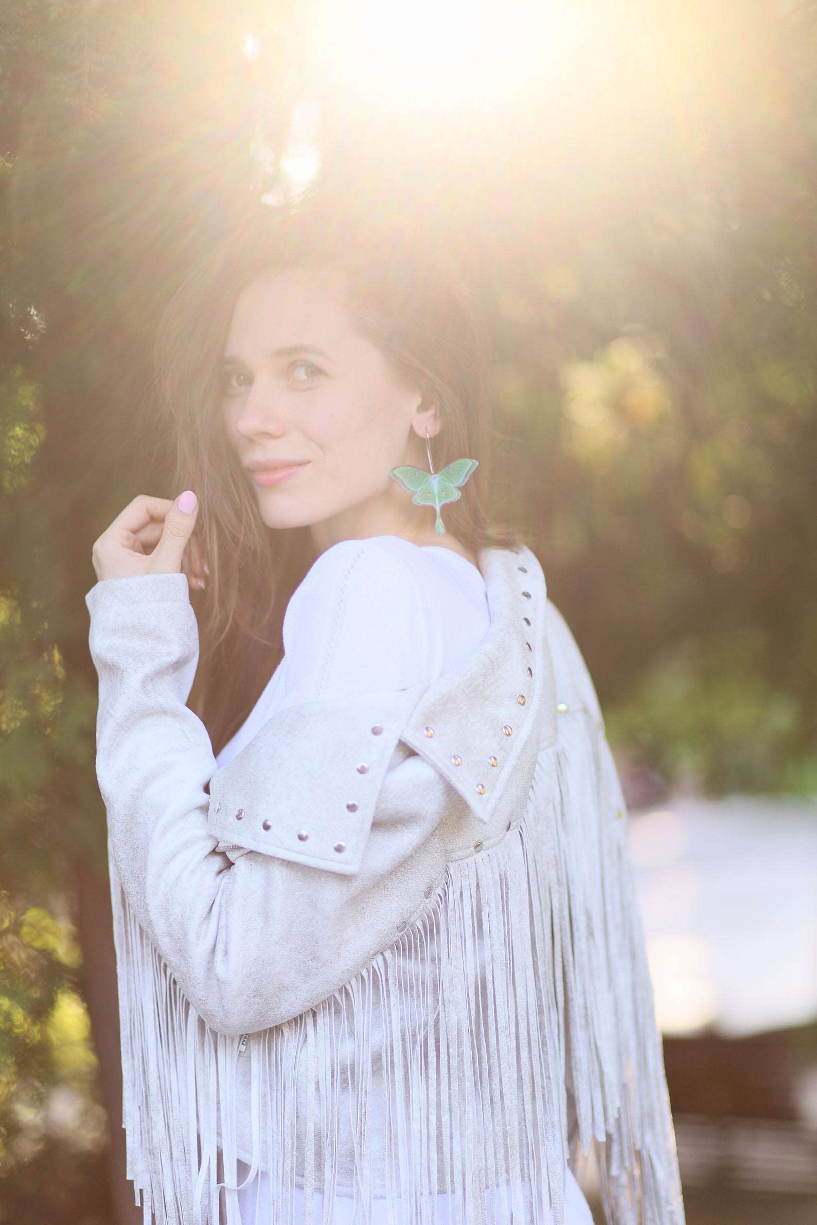 Young girl with luna moth earrings in jacket