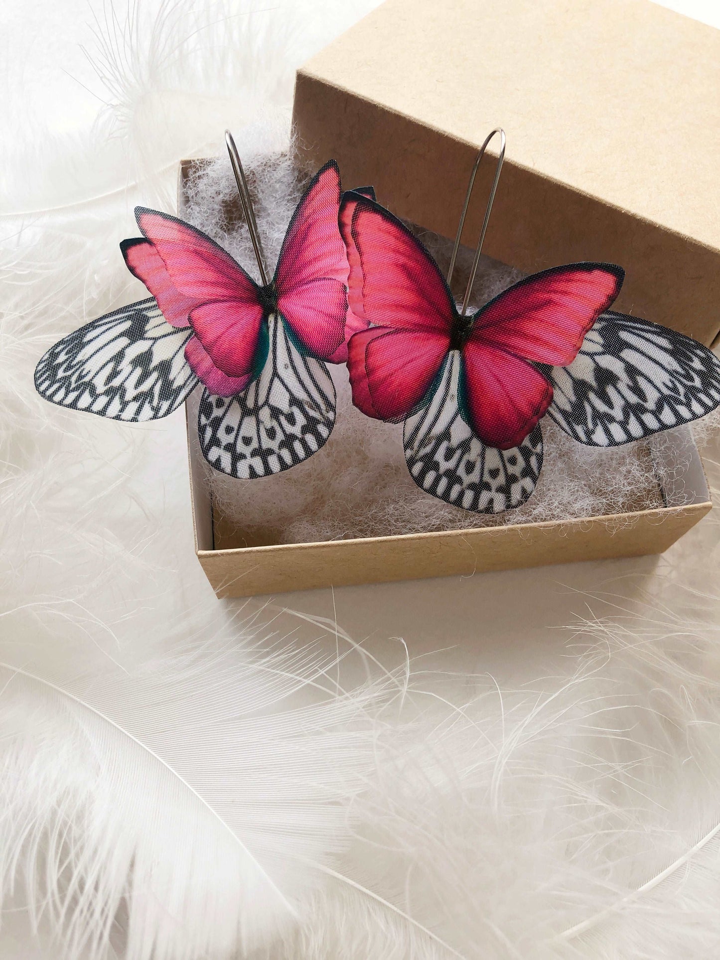 Hot pink moth earrings with whimsical design