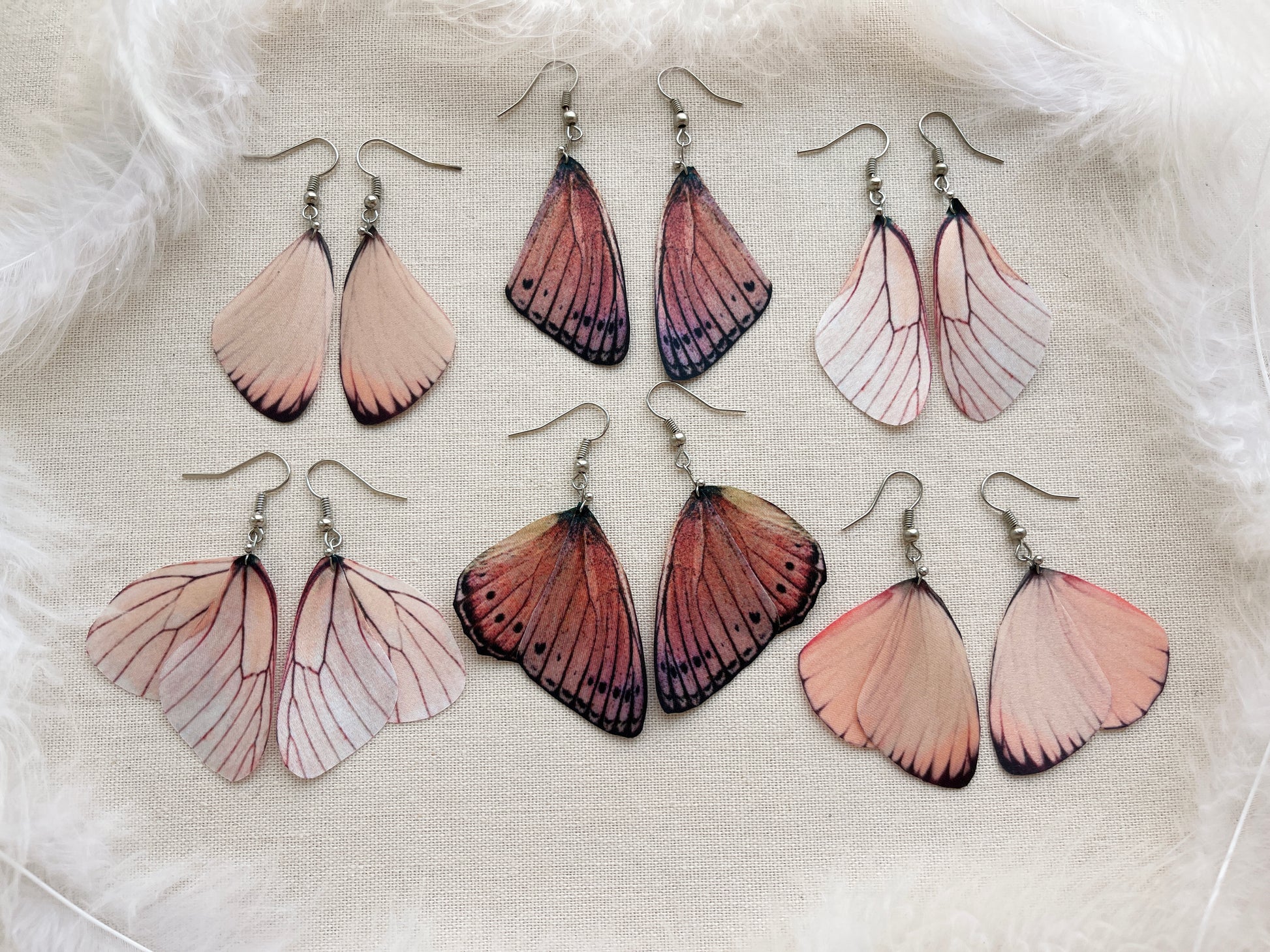 Pink Butterflies Earrings on Beige Background