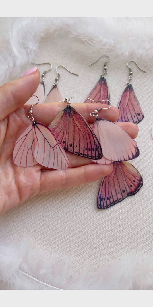 Pink Butterflies Earrings on Beige Background with White Feathers