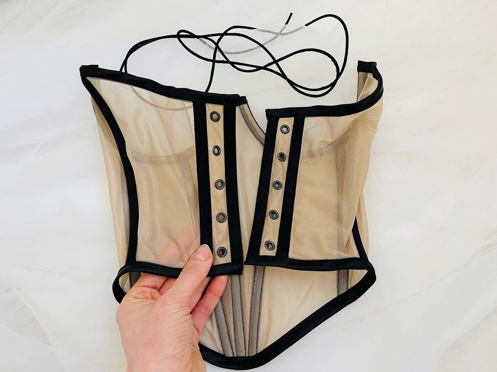 Nude cupless corset top with delicate lace detailing and handmade construction