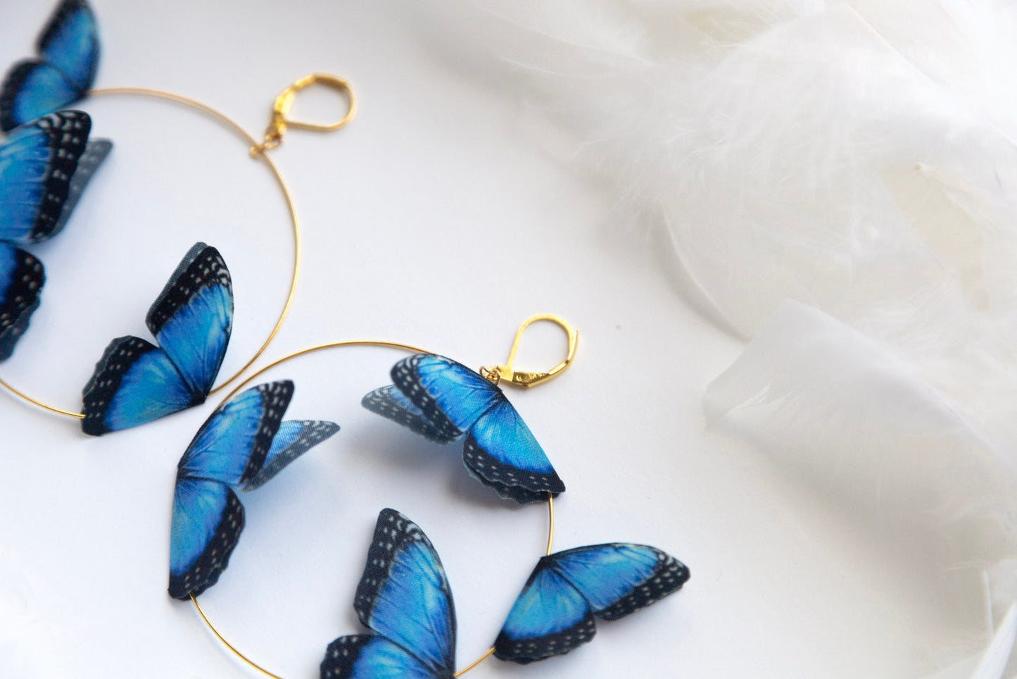 Pair of handmade butterfly hoop earrings in gold and blue