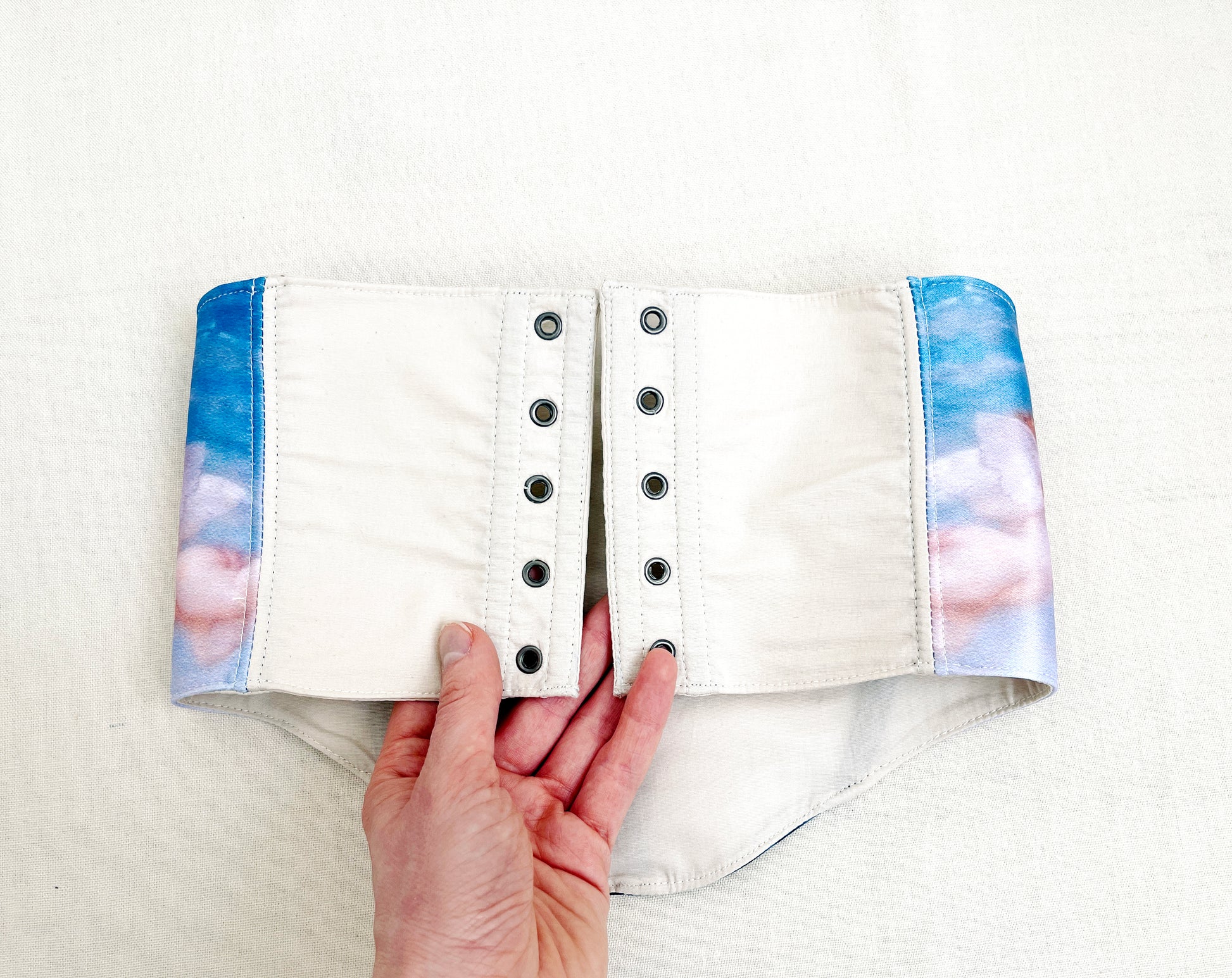 Detailed view of Cabanel-inspired Renaissance motif on handmade corset belt with lacing