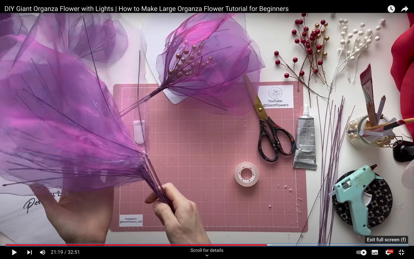 DIY Giant Organza Flower with Lights tutorial on a table with materials and tools.