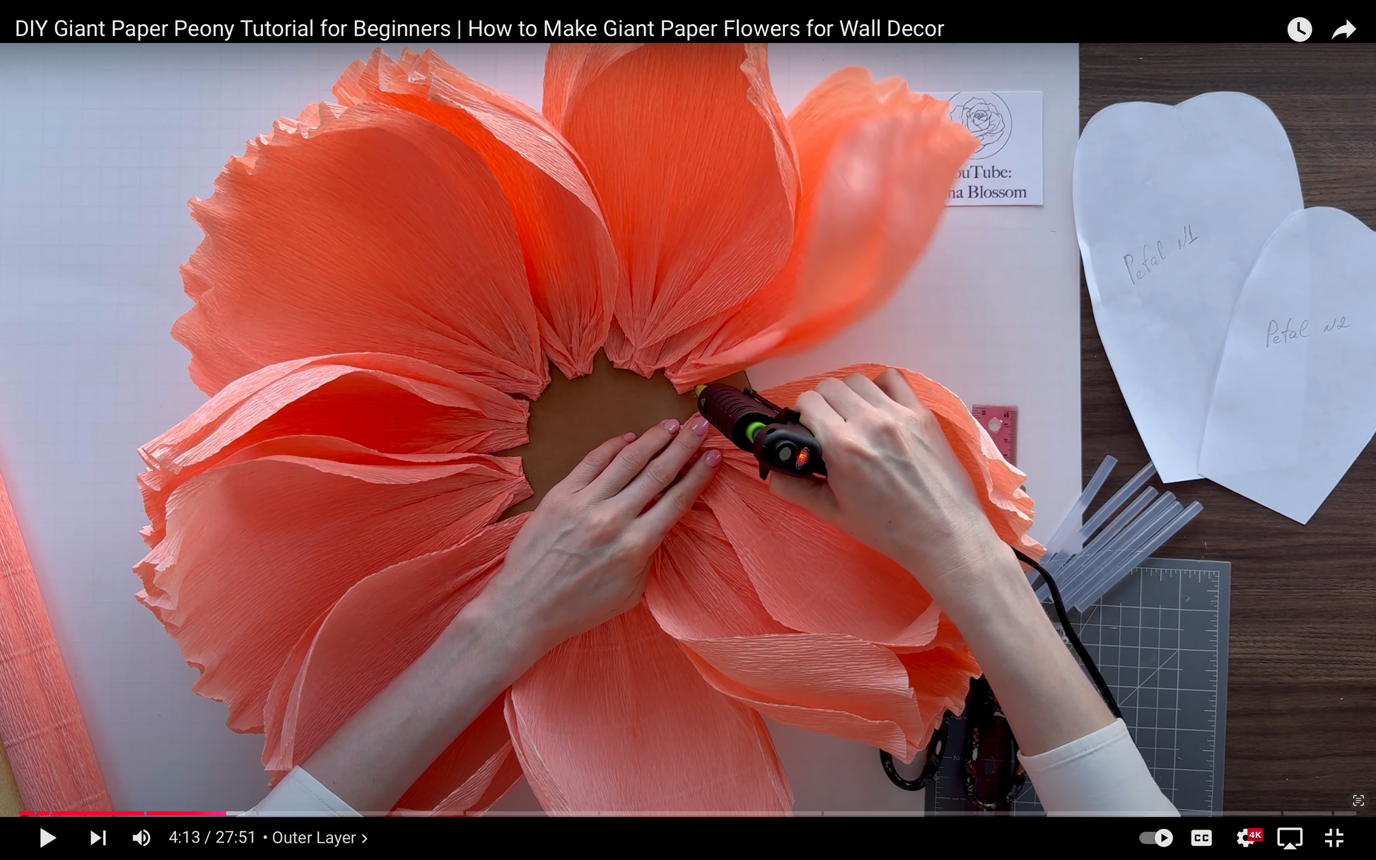 Alina Blossom making a giant paper flower with tools on a table