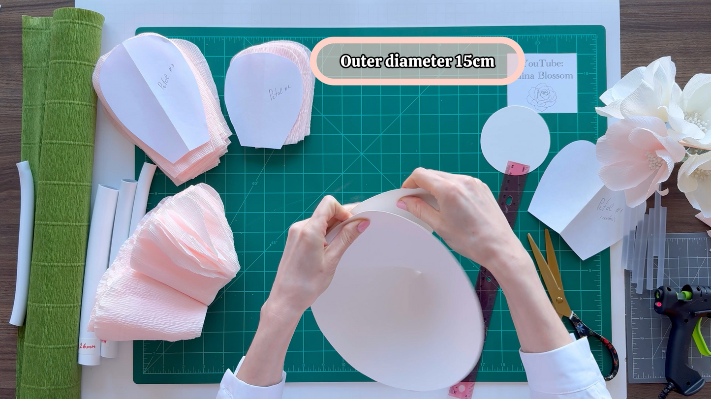 Alina Blossom working with paper flowers on a cutting mat, with text indicating outer diameter of 15cm.