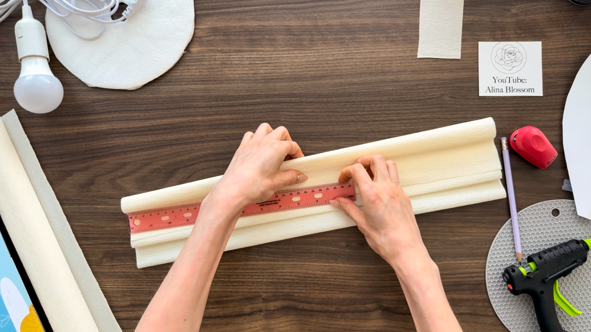 Measuring and folding crepe paper for DIY flower light template