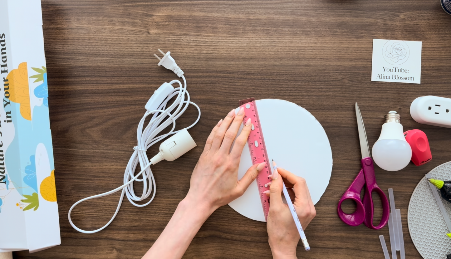 Hands cutting crepe paper petal for giant flower lamp template by Alina Blossom