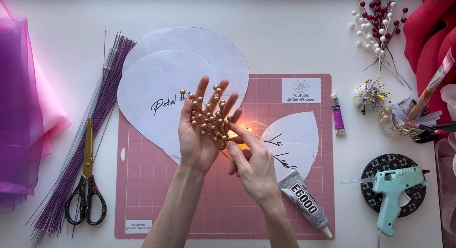 Alina Blossom crafting with decorative elements on a table with supplies