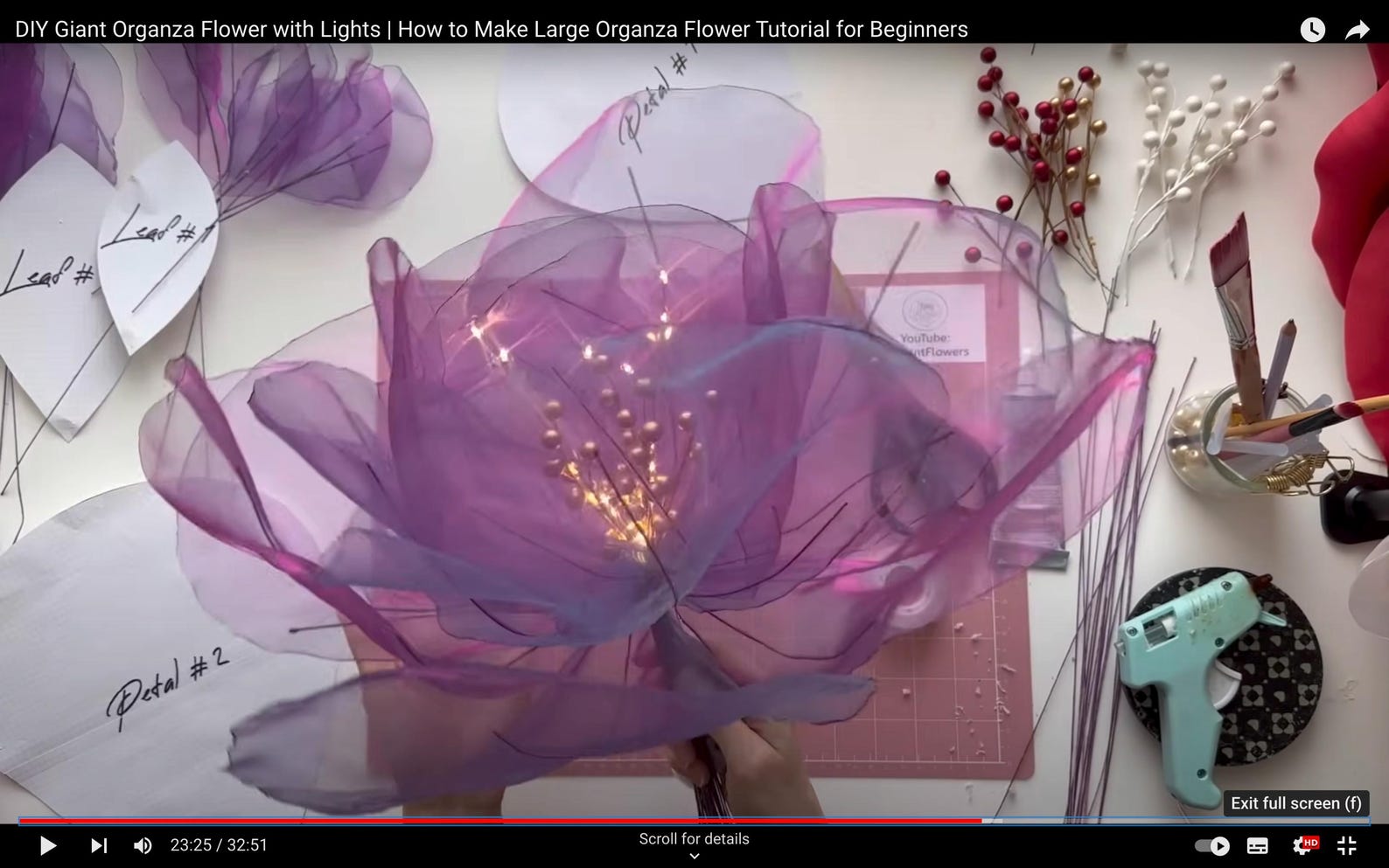 DIY Giant Organza Flower with Lights tutorial on a white surface with tools and materials.