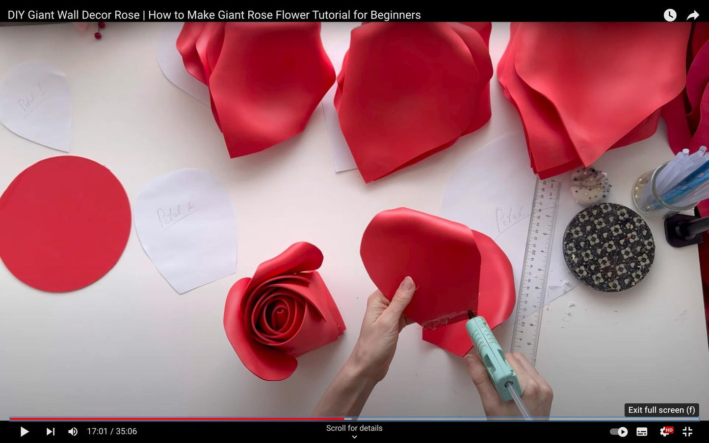 DIY Giant Rose Flower Tutorial for Beginners with red foam flowers and tools on a white surface.