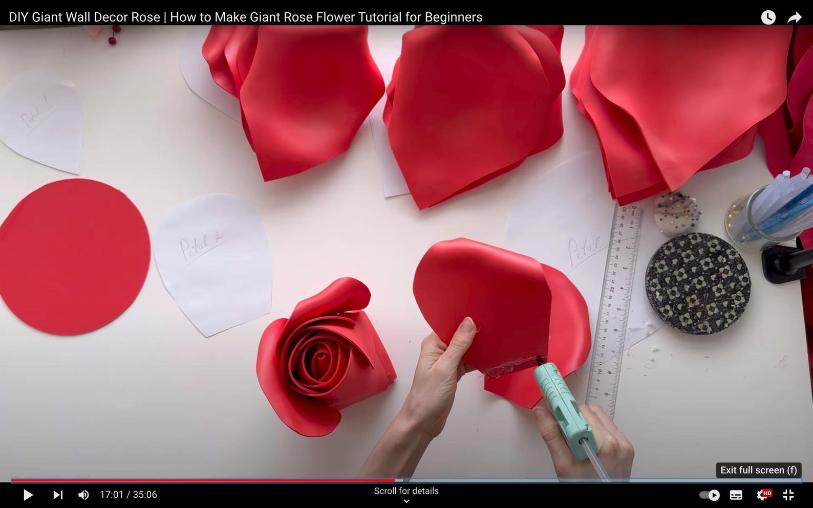 DIY Giant Rose Flower Tutorial for Beginners with red foam flowers and tools on a white surface.