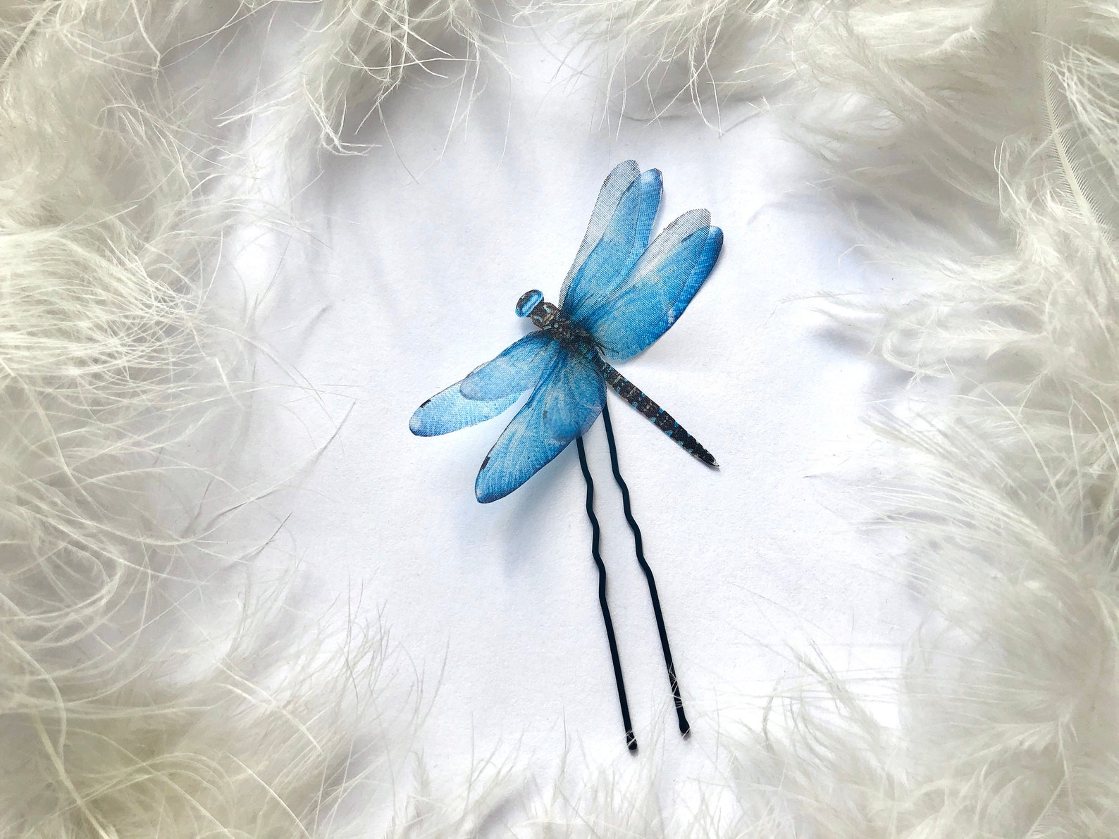 Blue silk dragonfly hairpin on a white background, featuring delicate organza wings