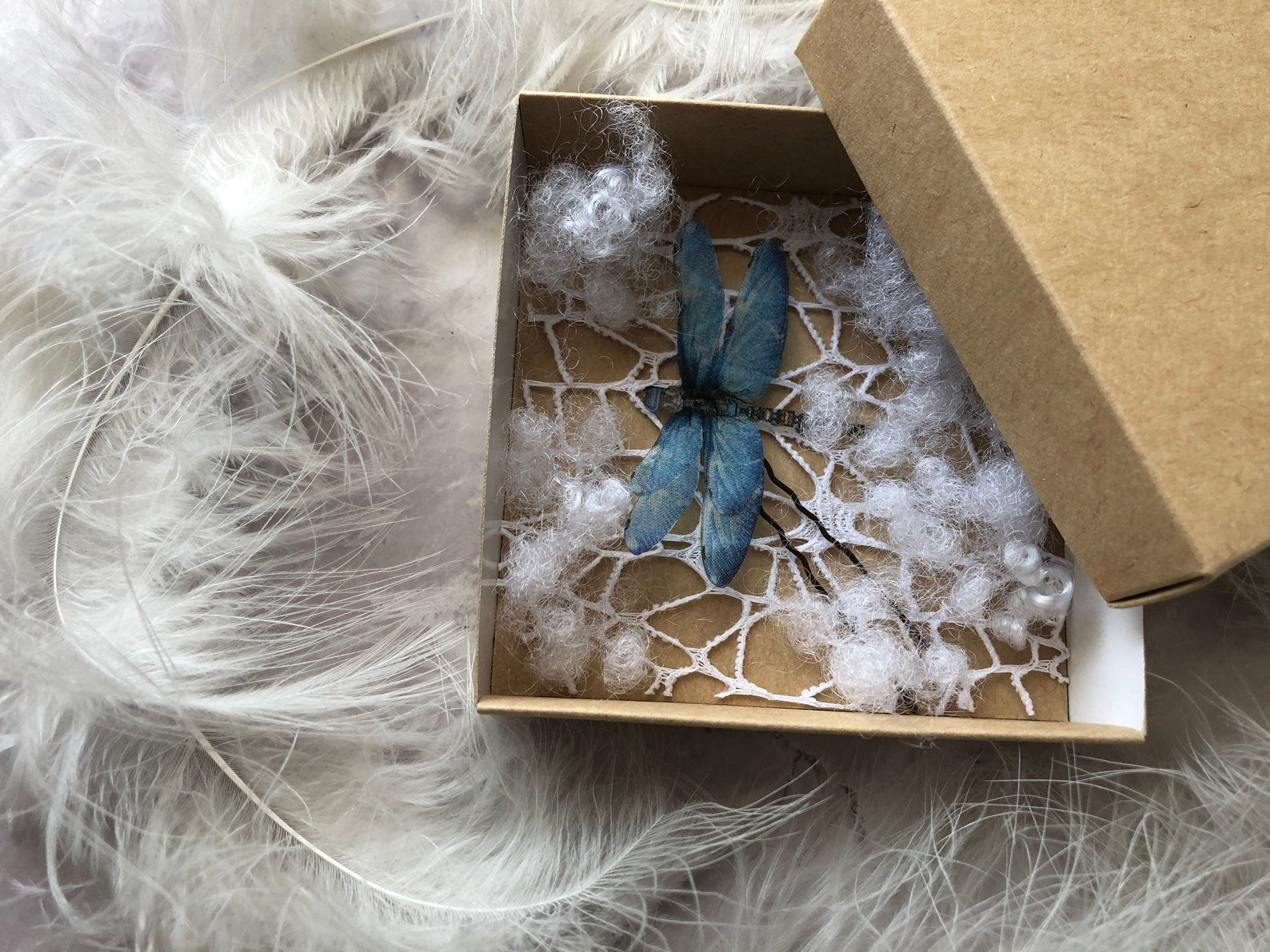 Elegant packaging of a blue dragonfly hair clip, making it a thoughtful gift choice