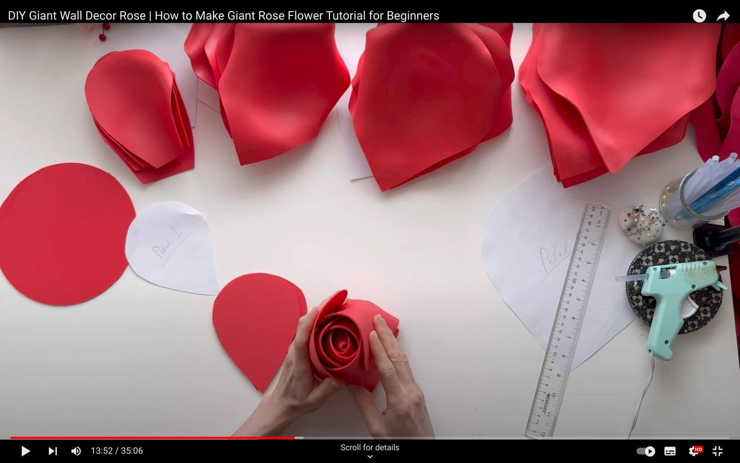 DIY Giant Rose Flower Tutorial for Beginners with red foam petals and crafting tools on a white surface.