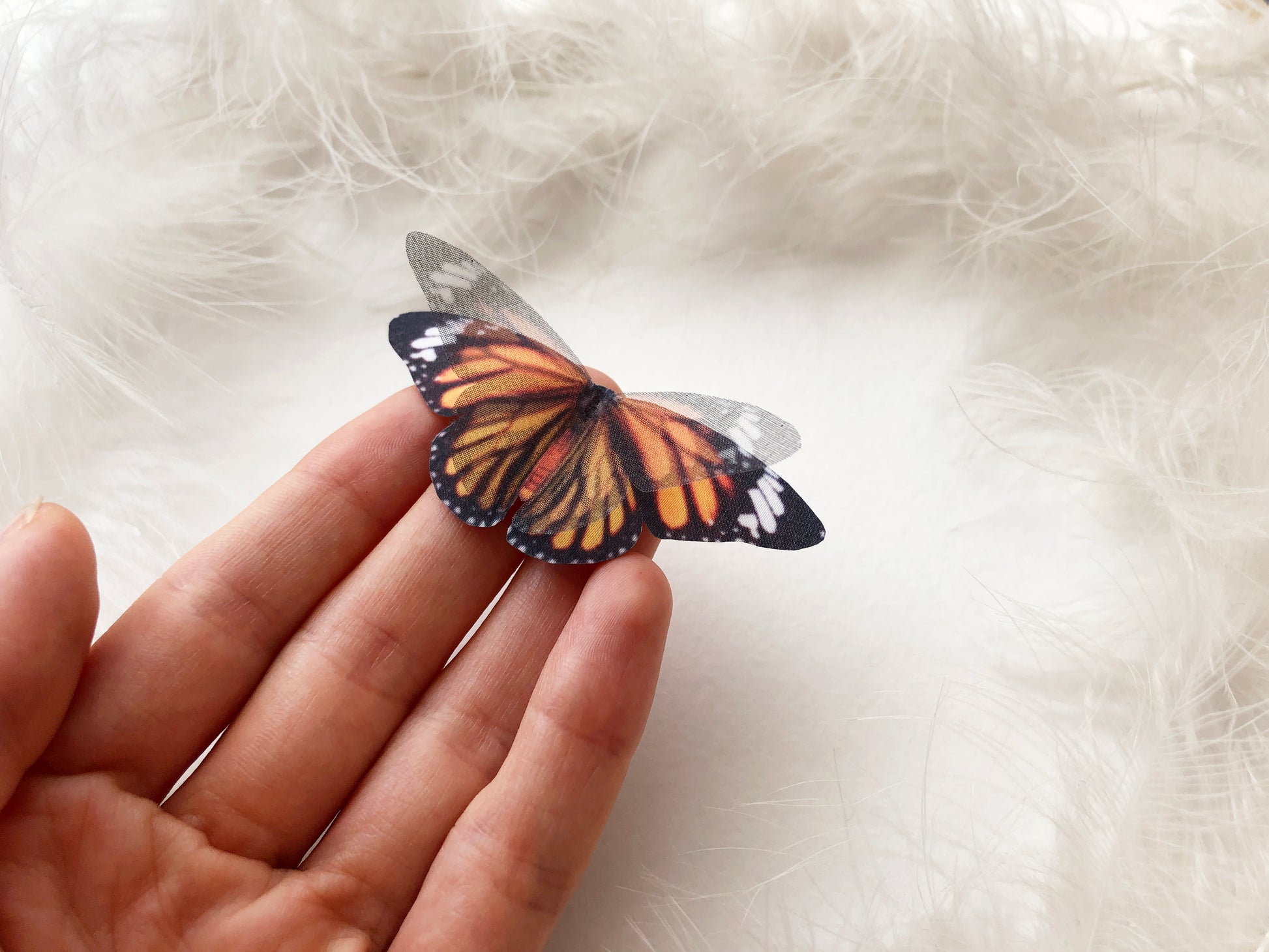Faux Monarch Butterfly on Hand with White Background