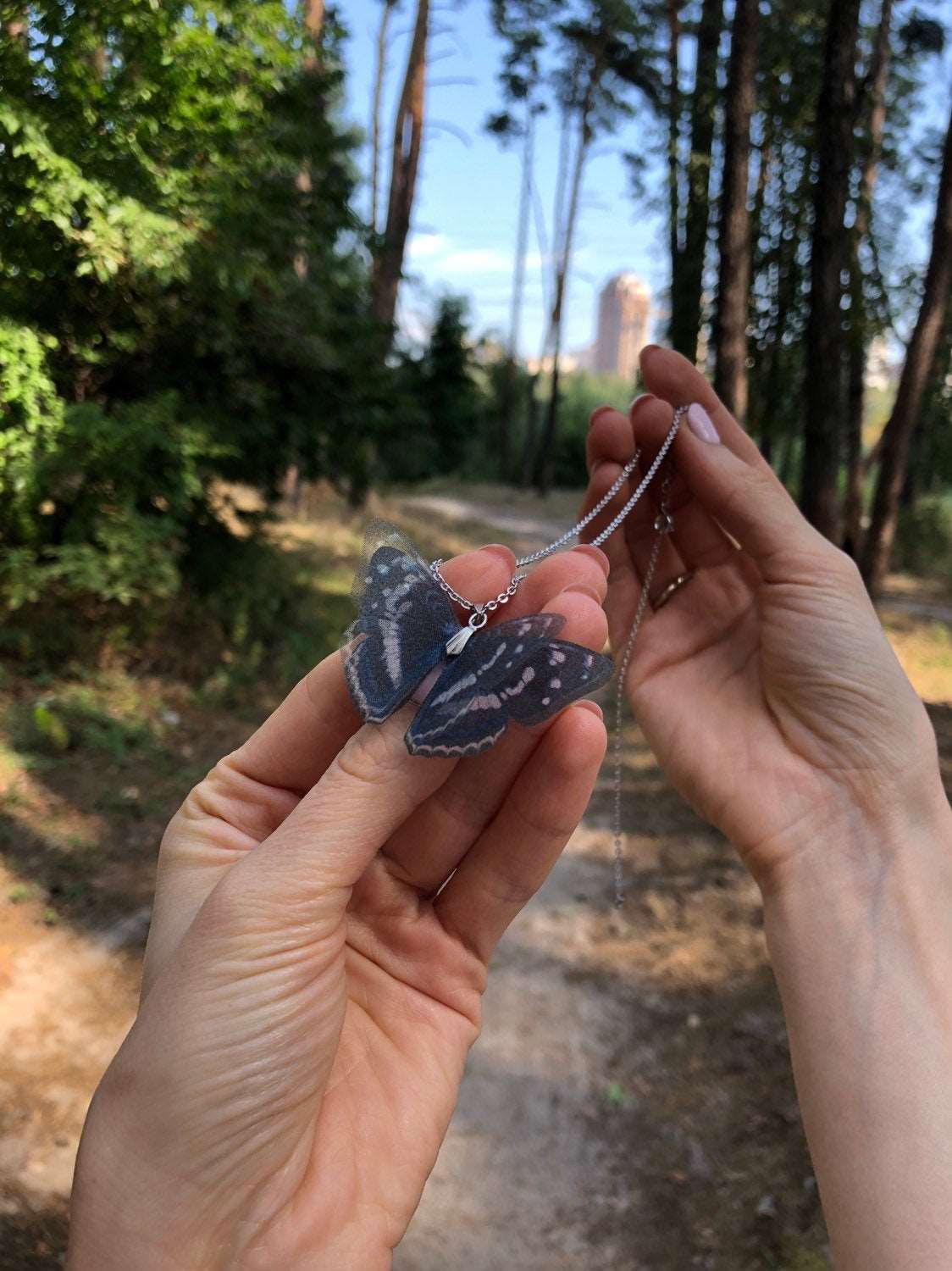 Side view of the Whimsigoth Necklace with butterfly pendant