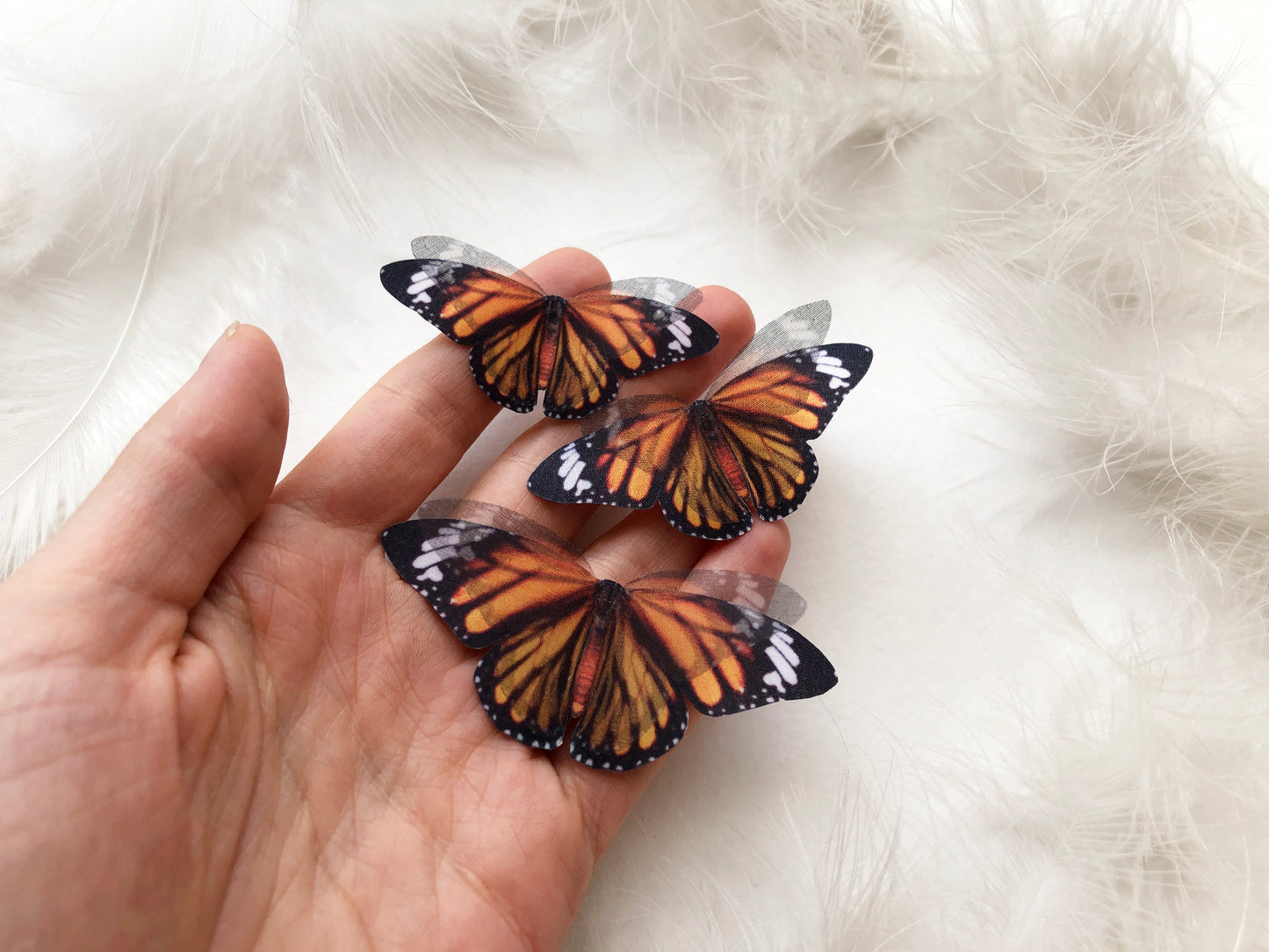 3 Monarch Butterflies on hand with white background