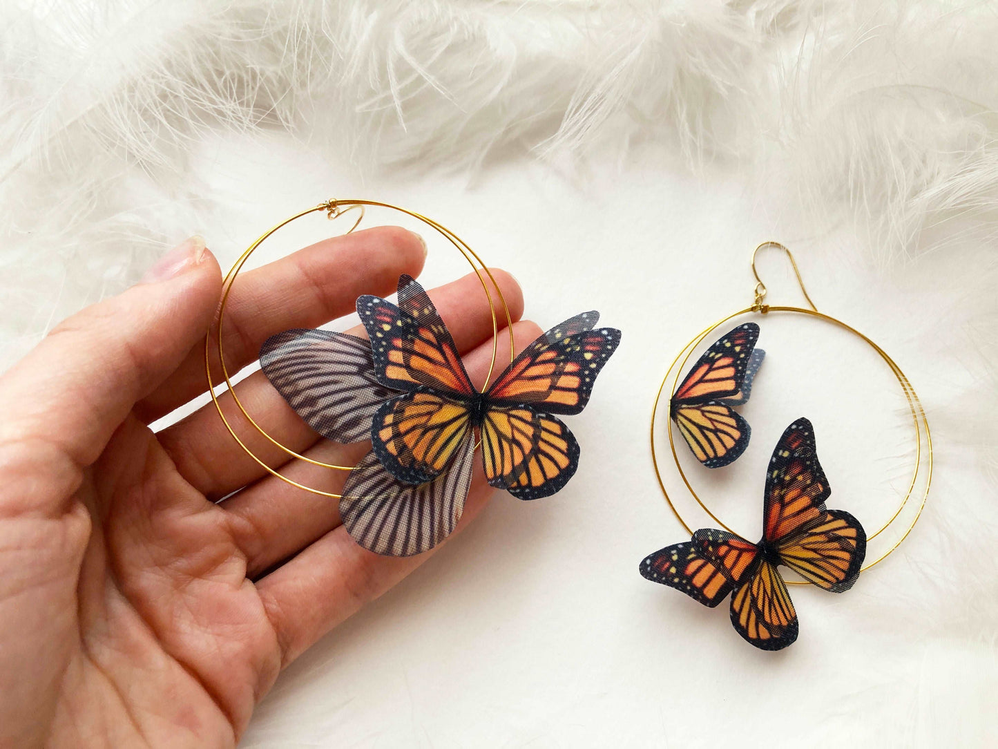 Close-up of Monarch Butterfly Hoop Earrings with colorful butterfly detail