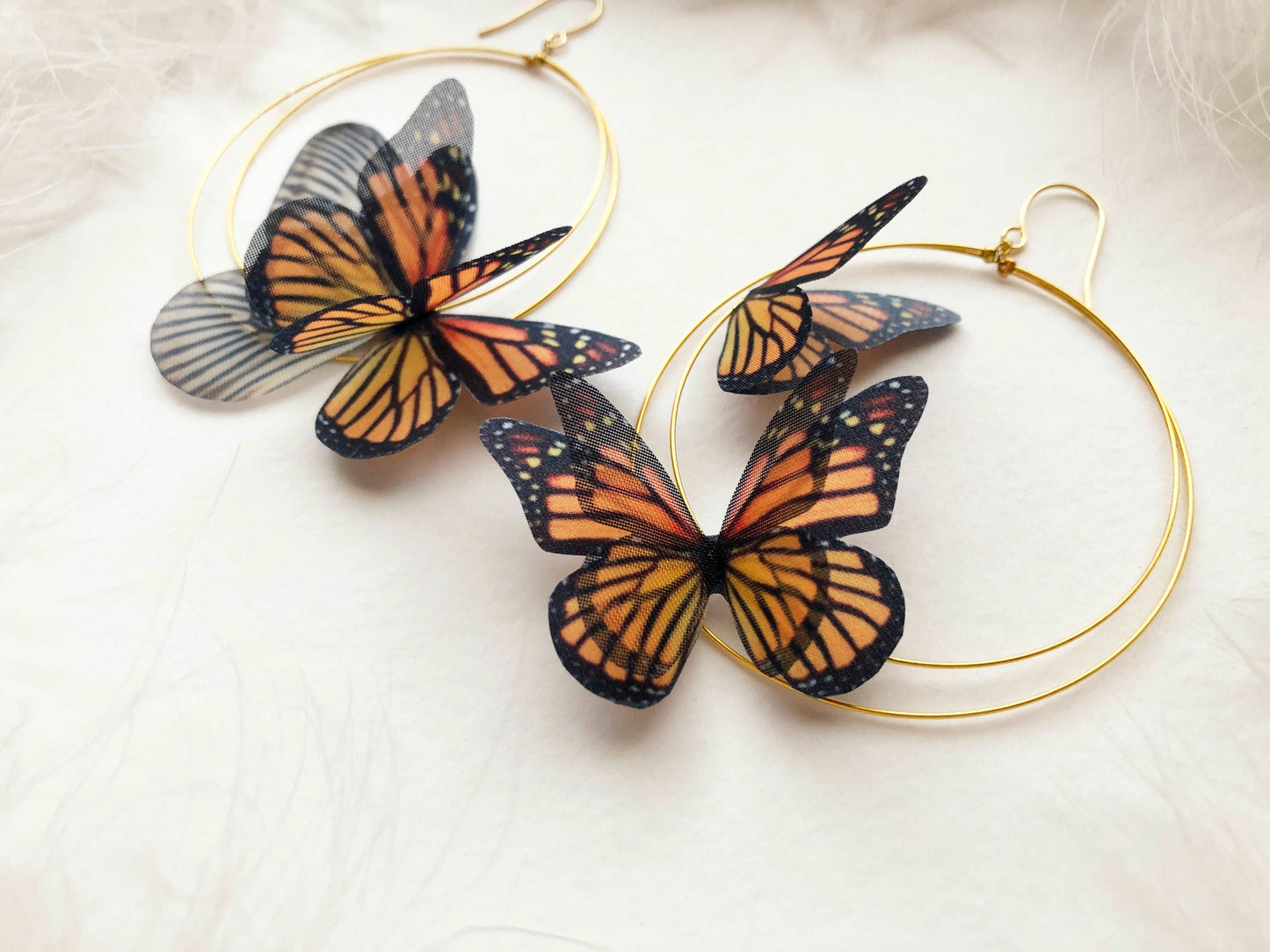 Close-up of the delicate butterfly wings on the Monarch Butterfly Hoop Earrings