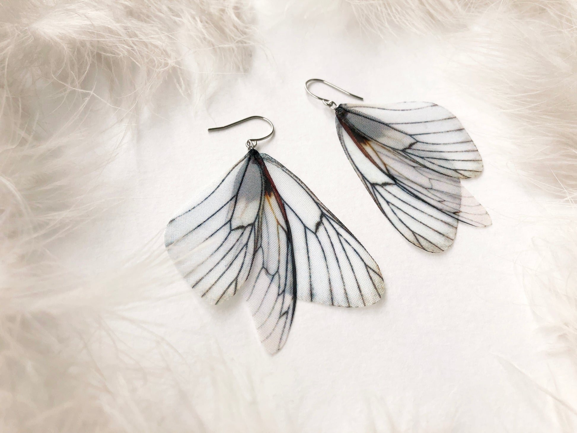 White butterfly earrings handmade of silk on white background