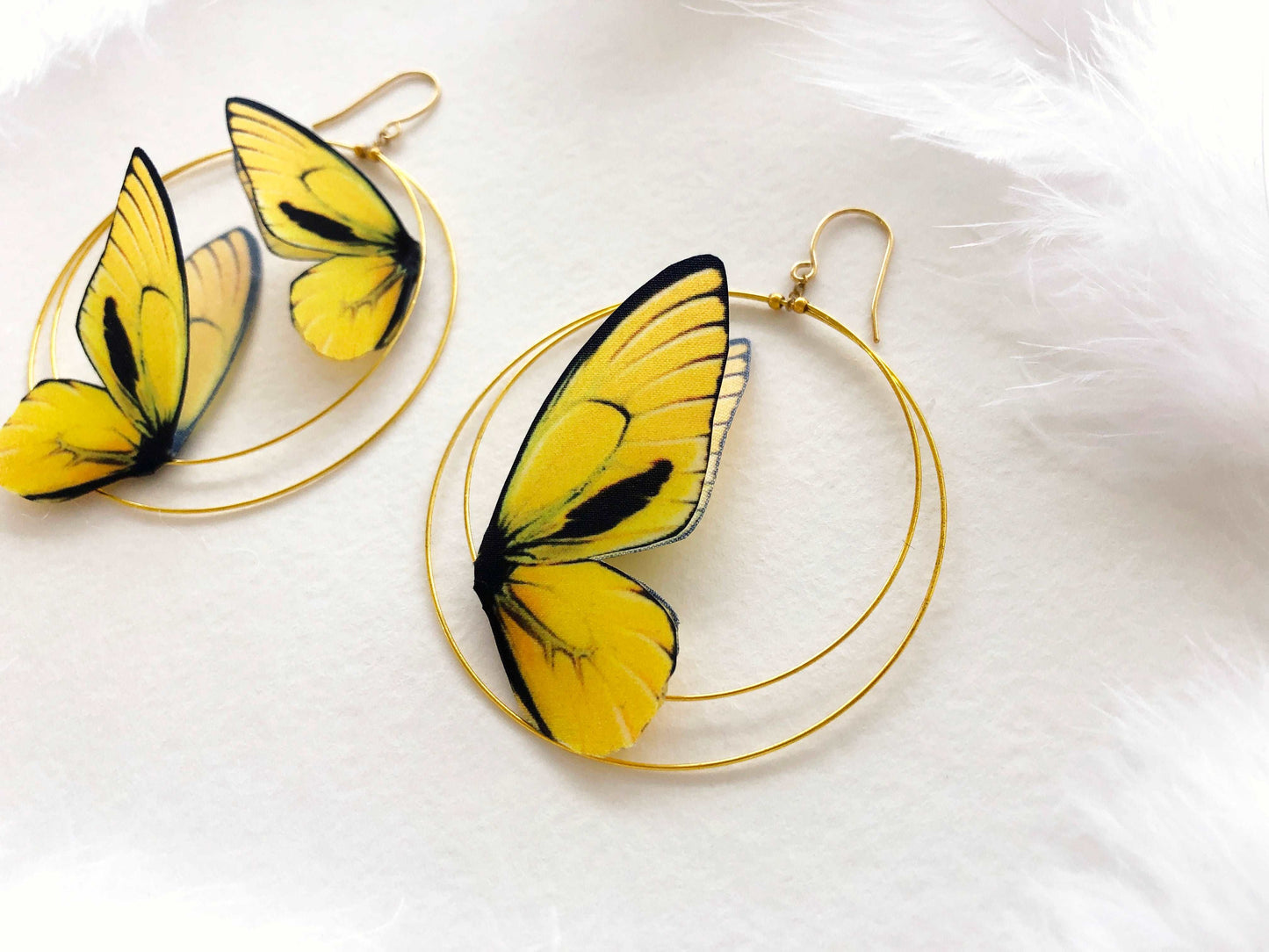 Double Hoop Earrings with Yellow Butterflies on White Background and White Feathers