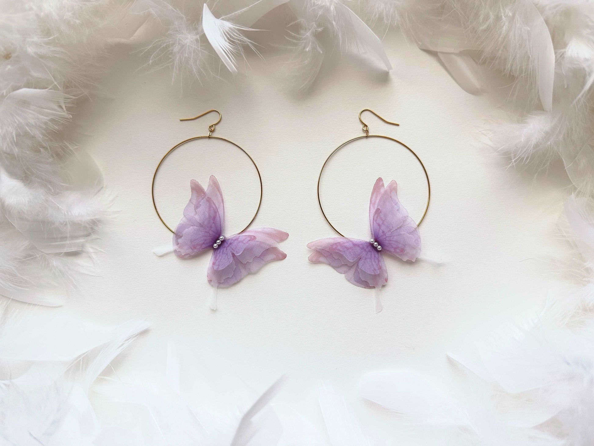 Purple hoop earrings with butterflies