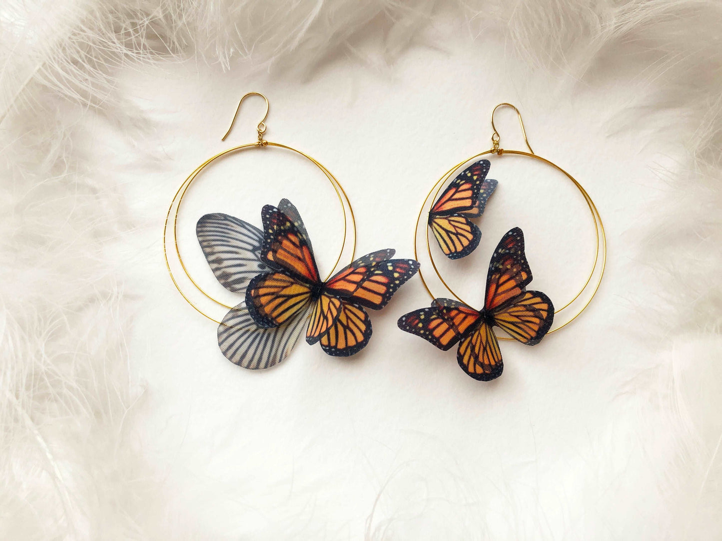 Close-up of the faux Monarch Butterflies on the hoop earrings