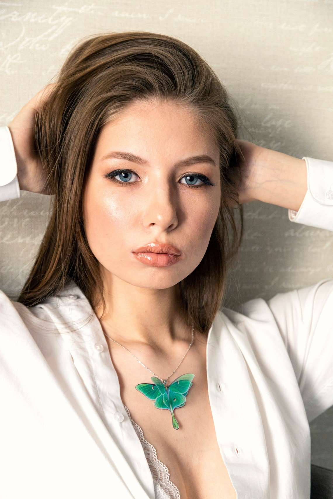 Model wearing the Green Lunar Moth Pendant - A beautiful and meaningful piece of jewelry for any occasion