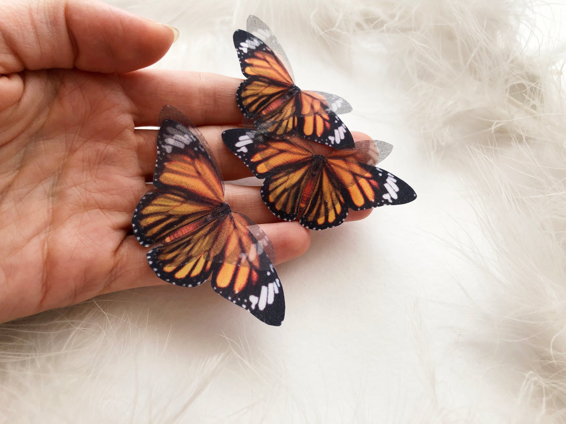 Set of 3 3D Faux Monarch Butterflies on a Hand with White Background