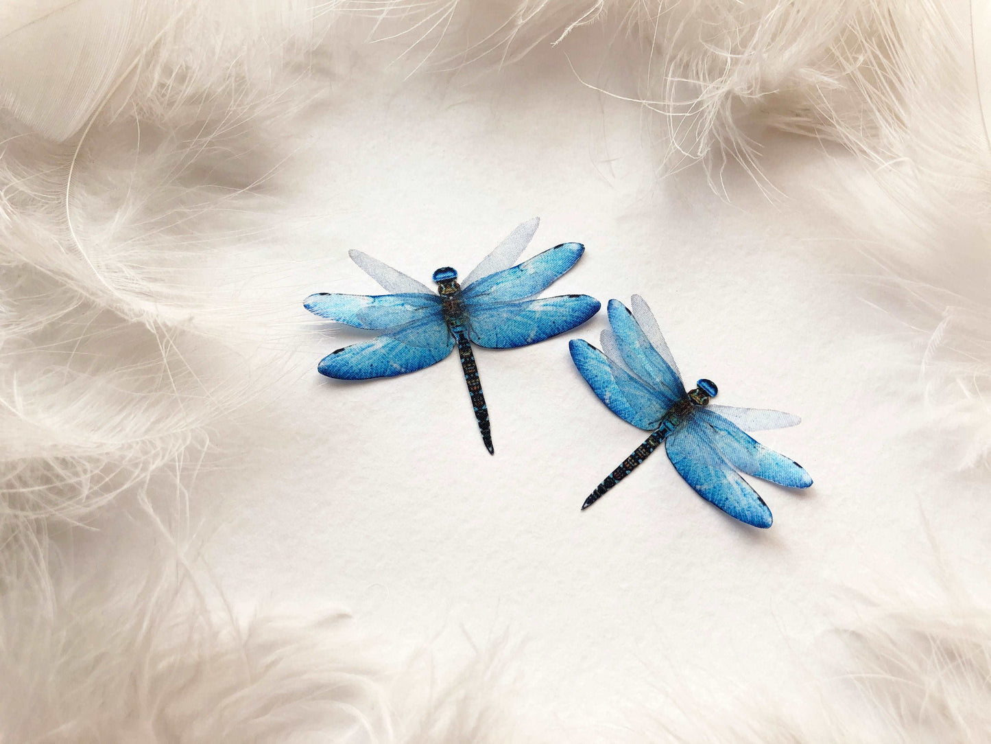 2 Blue Faux Dragonflies handmade on White Feathers Background