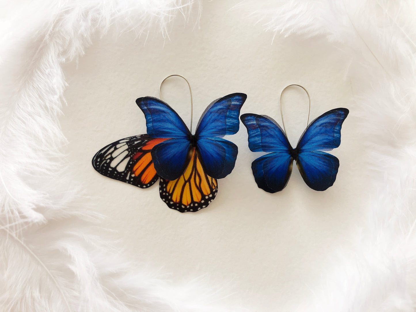 Handmade butterfly earrings with blue monarch wings and floral details