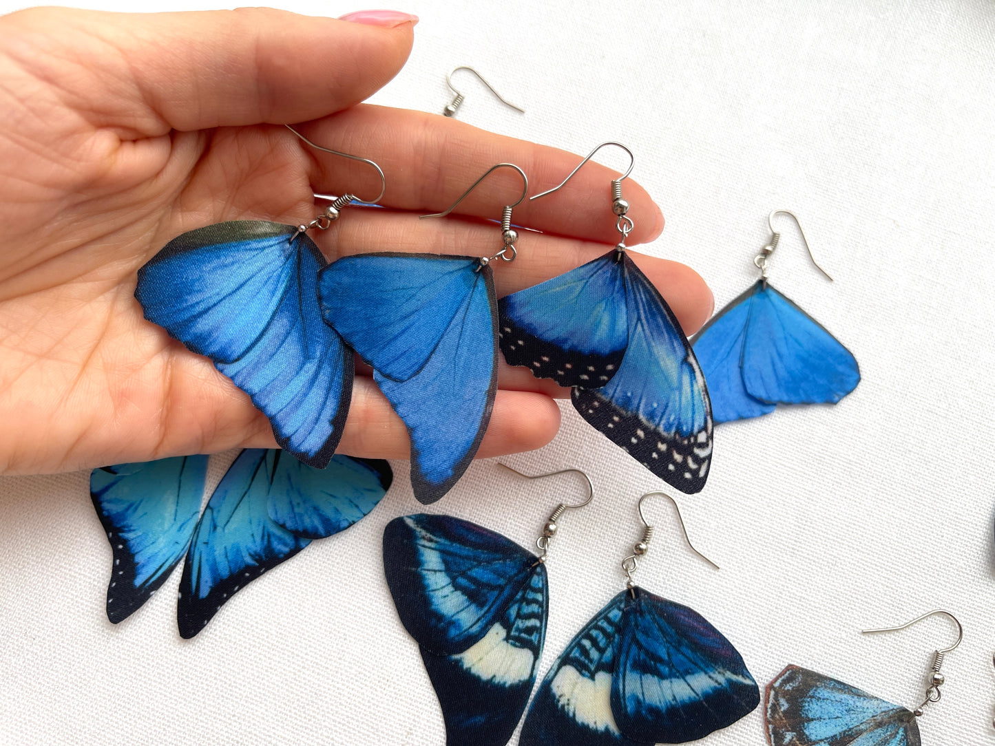 Dainty blue butterfly earrings with intricate wing details