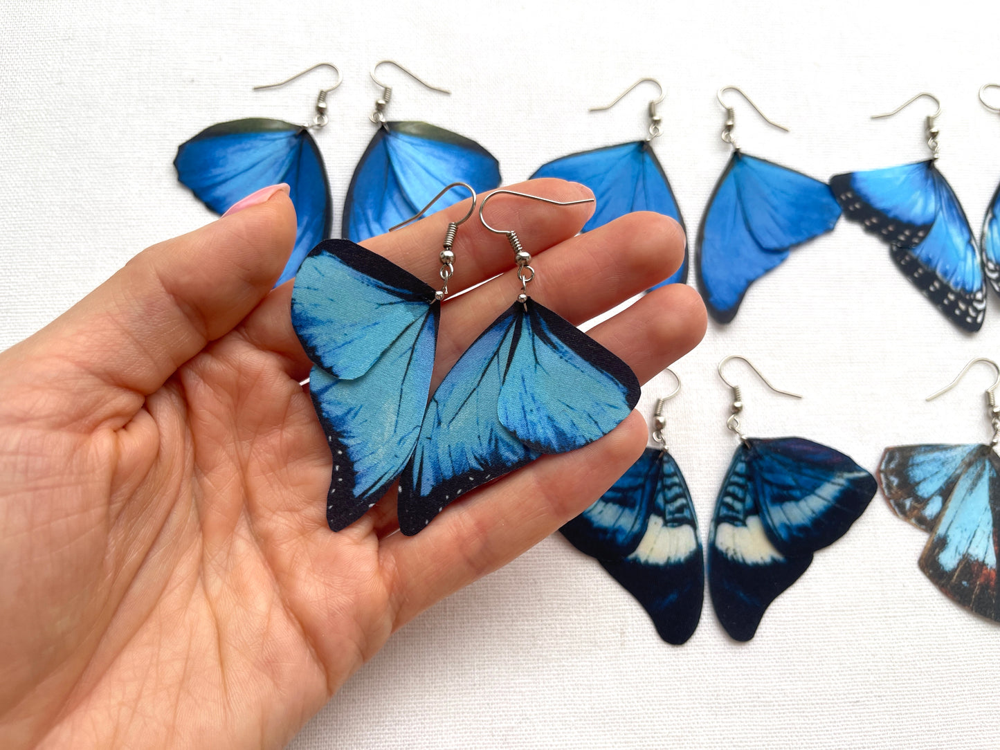 Watercolor butterfly wing earrings in shades of blue