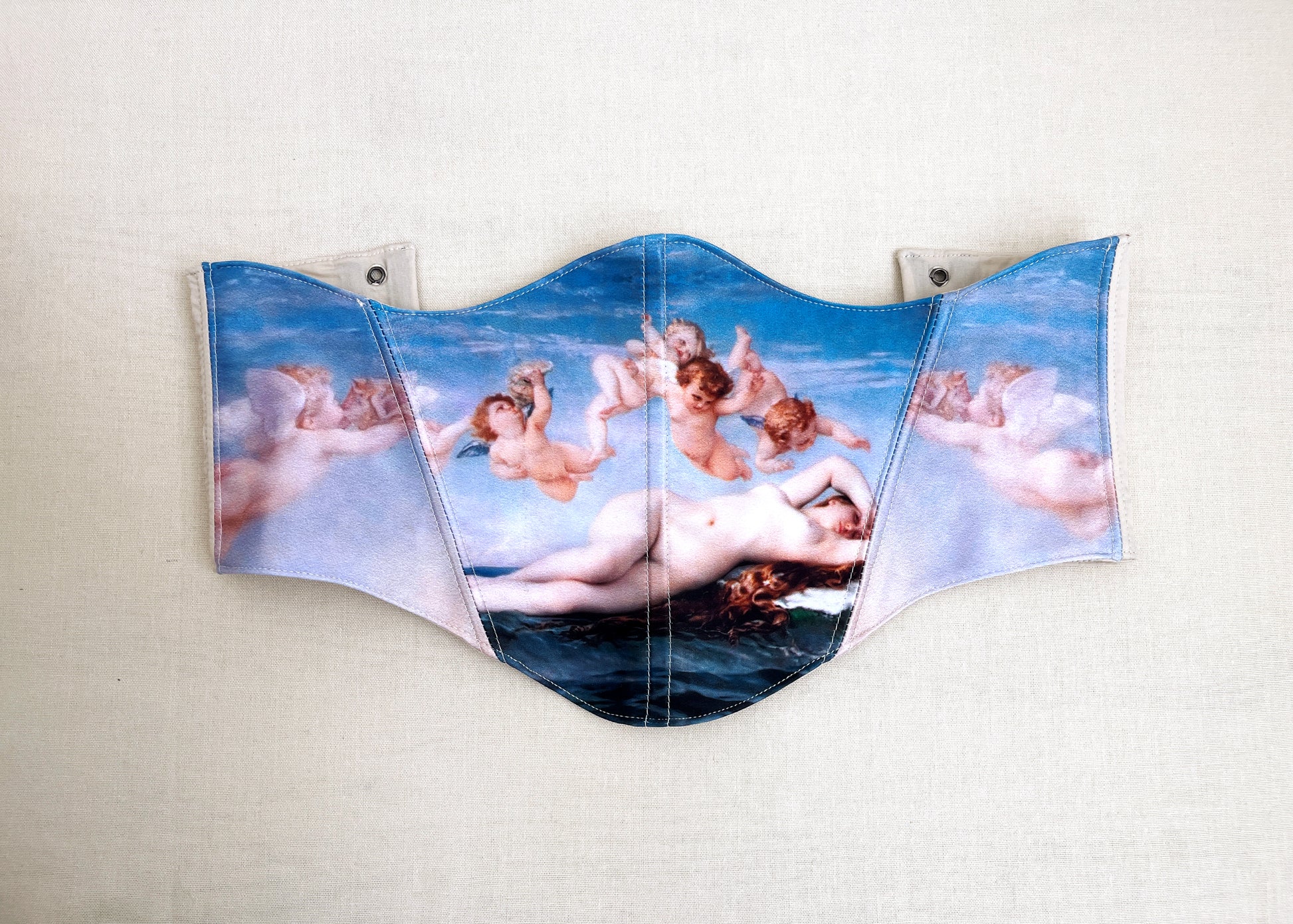 Blue corset with renaissance Venus oil painting on beige background