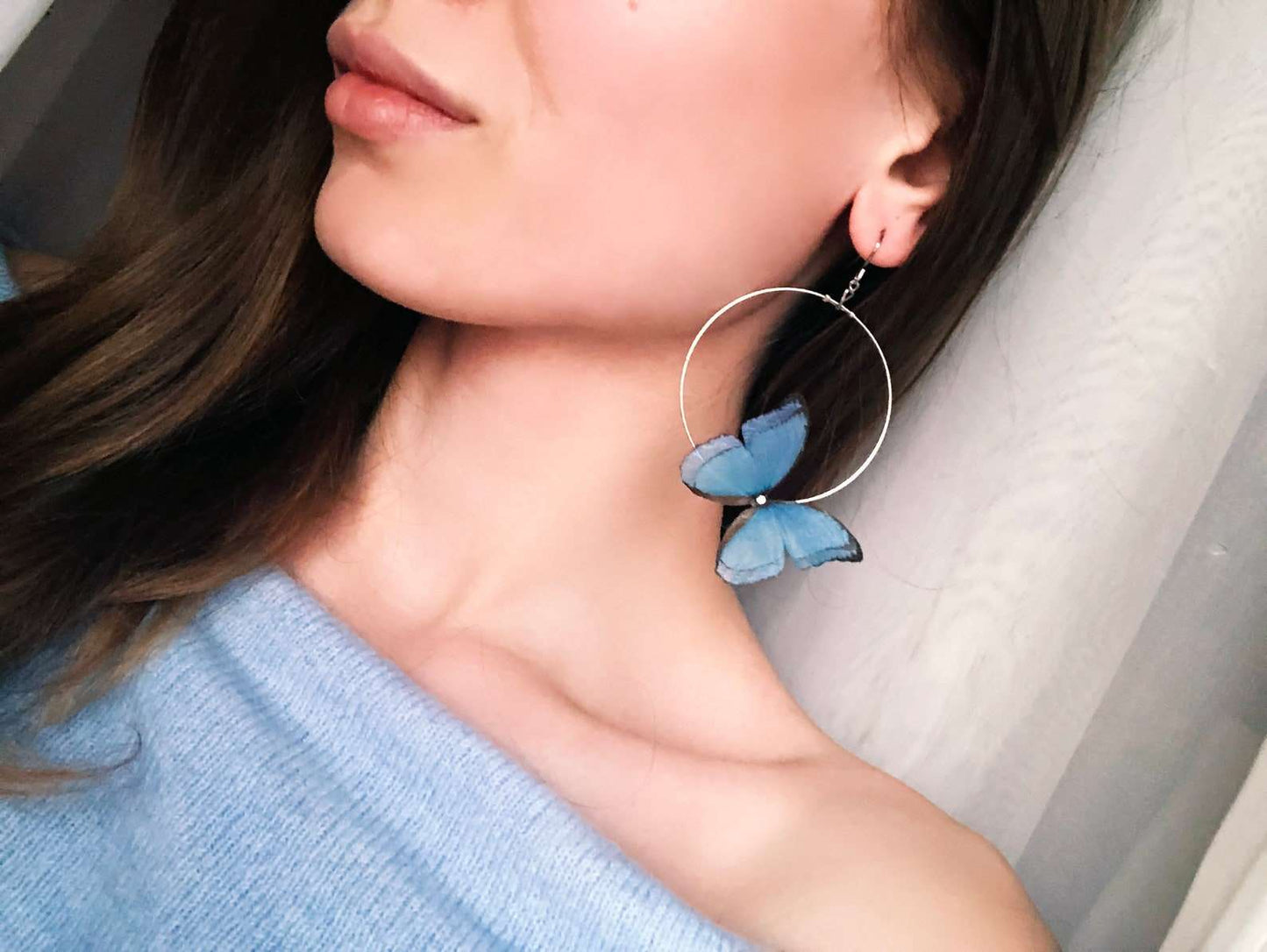 Blue Butterfly Hoop Earrings from the Side on White Background