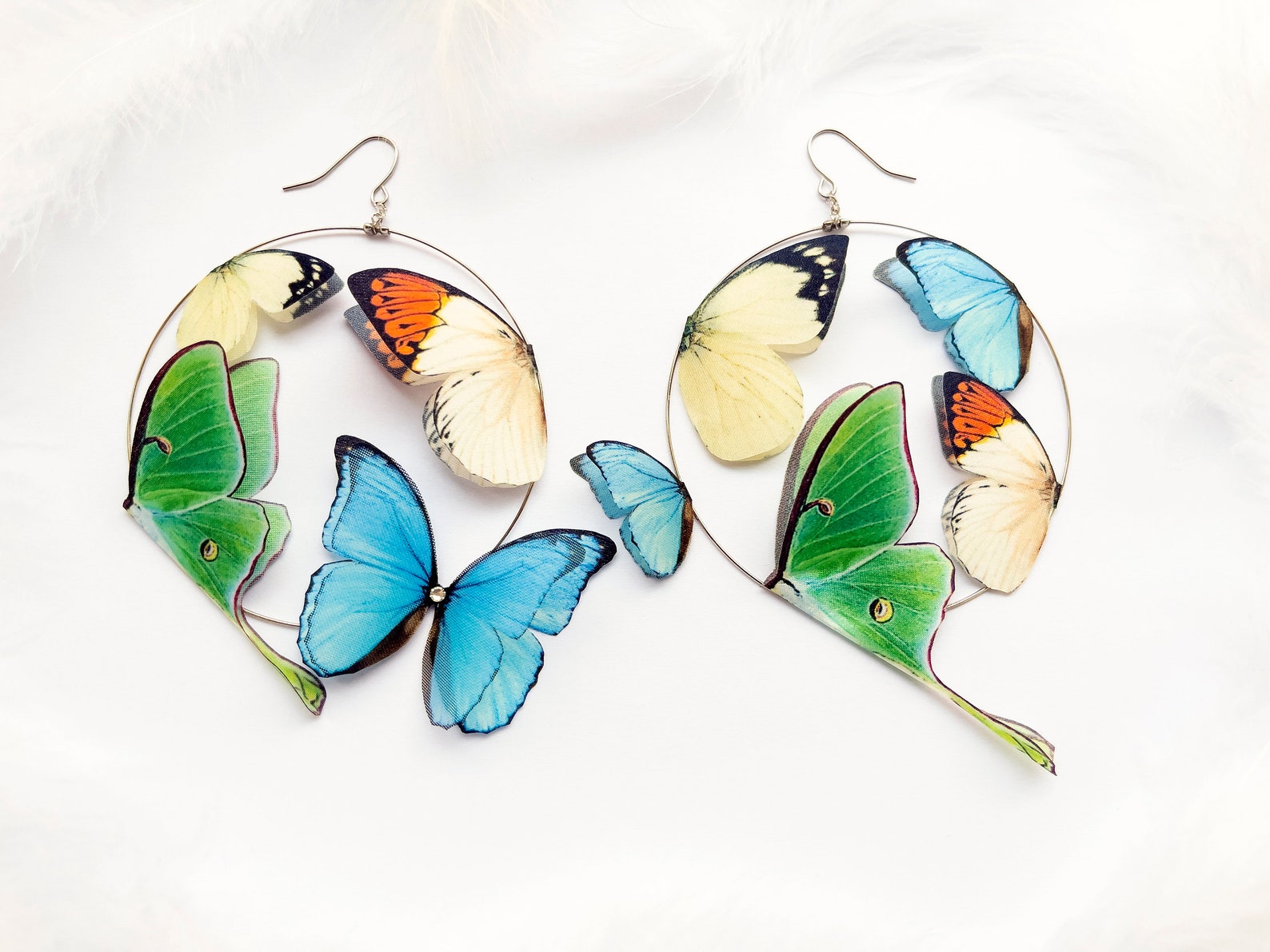 Boho style Luna moth and butterfly earrings on silver hoops