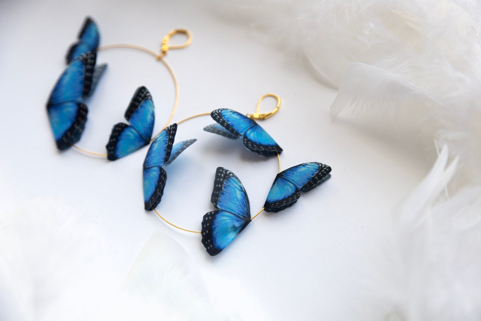 Gold plated thin hoop earrings with sapphire blue butterfly charms