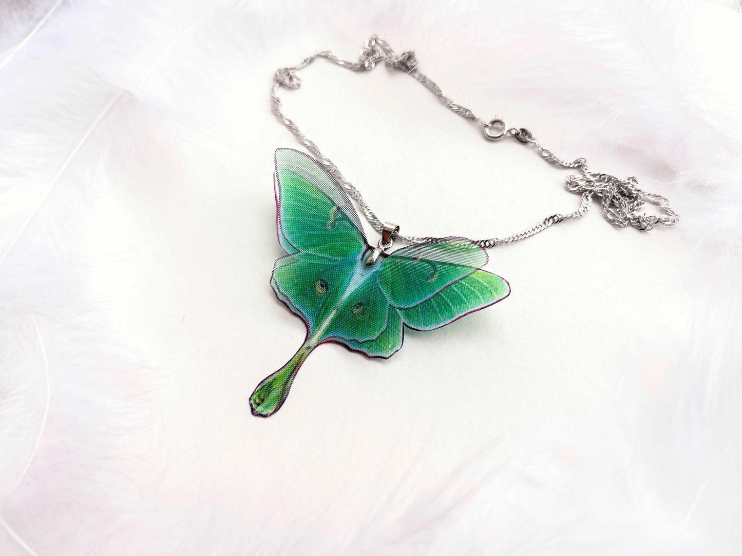Close-up of the stunning green hues of the Green Lunar Moth Pendant - A calming and serene addition to your jewelry collection